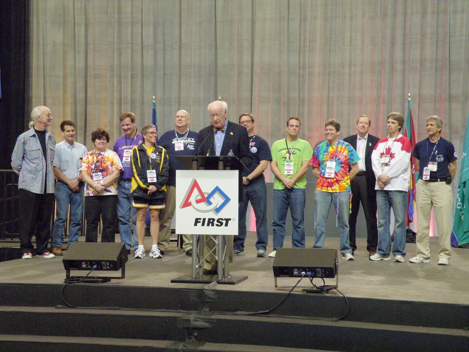 Dr. William Murphy speaking at the FIRST lectern with WFA recipients behind him on stage