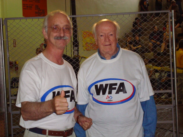 Dr. Woodie Flowers and Dr. William Murphy posing together wearing WFA shirts