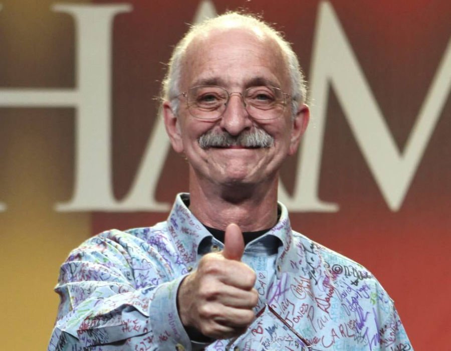 Dr. Woodie Flowers giving a thumbs up in a signed shirt
